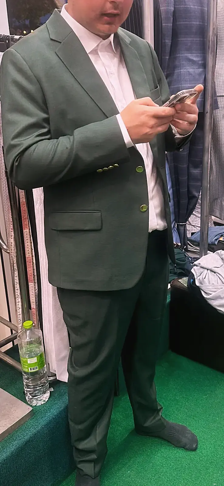 Client in an olive-green tailored suit