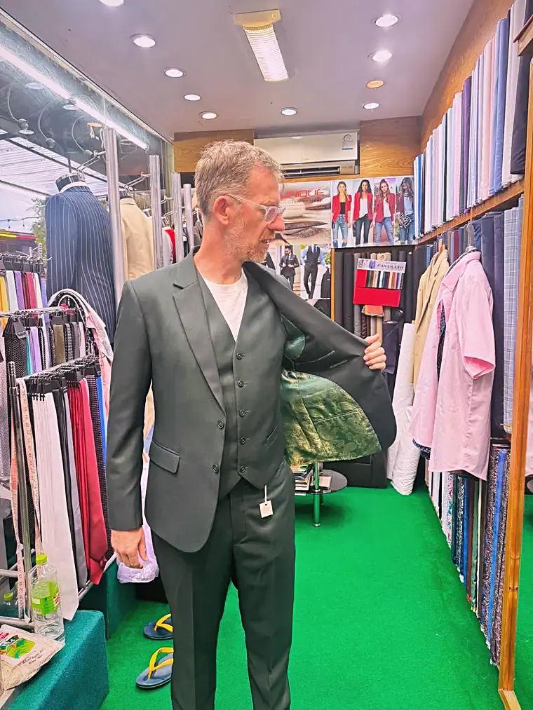 Client in an olive three-piece bespoke suit