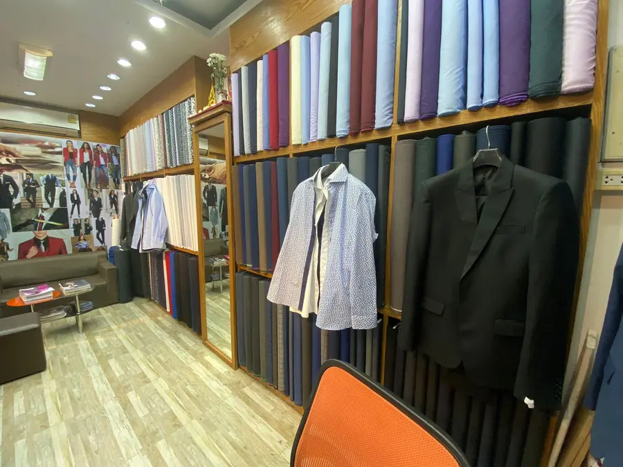 Fabric bolts lining the atelier walls